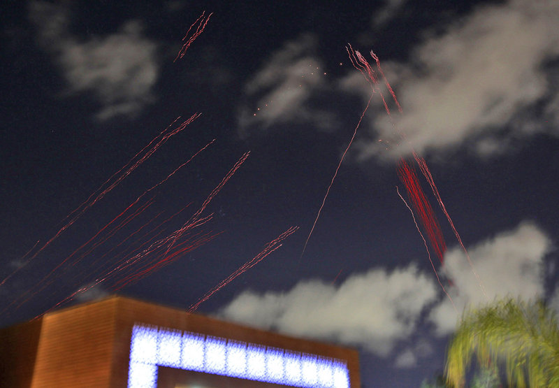 Tracers from anti- aircraft guns arc above the hotel where foreign media and government officials are staying in Tripoli.