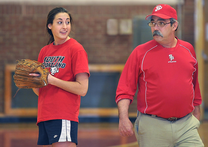 South Portland pitcher Alexis Bogdanovich seems happy to get the preseason under way as Coach Ralph Aceto keeps a watchful eye on proceedings at South Portland High on Monday.