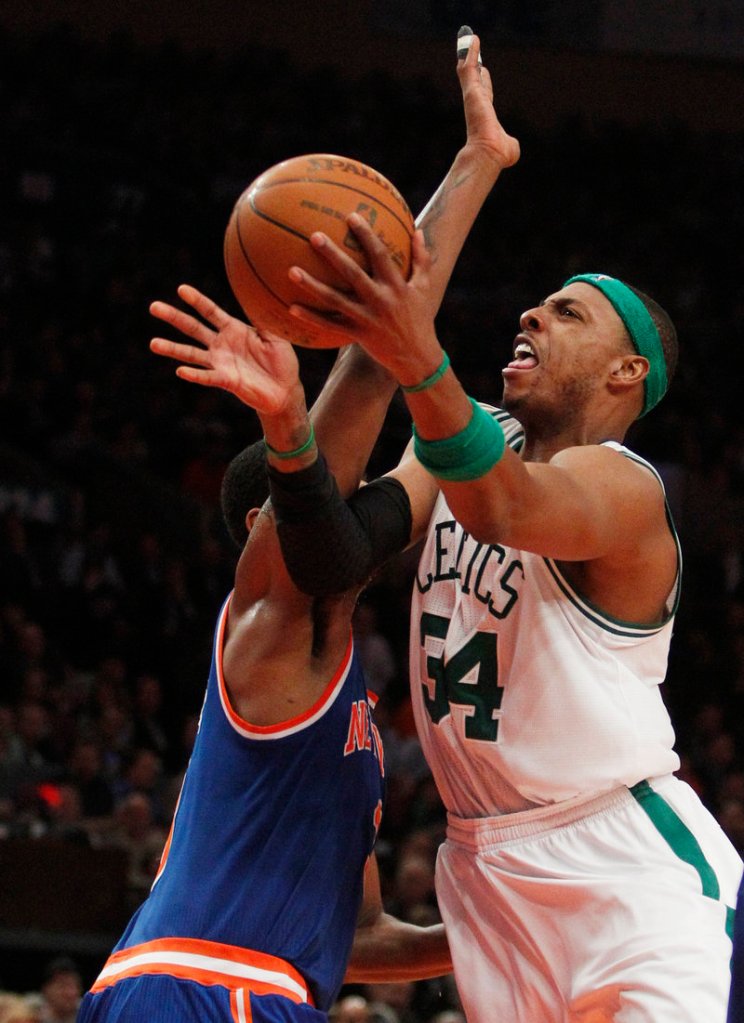 Paul Pierce shoots around New York’s Shawne Williams on Monday. Pierce hit 8 of 13 shots against the Knicks as he scored 21 points during the Celtics’ 96-86 win.
