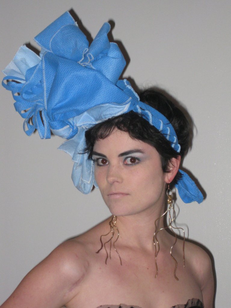 Beth Schneider models a blue wrap headdress designed by Gabriella Sturchio.
