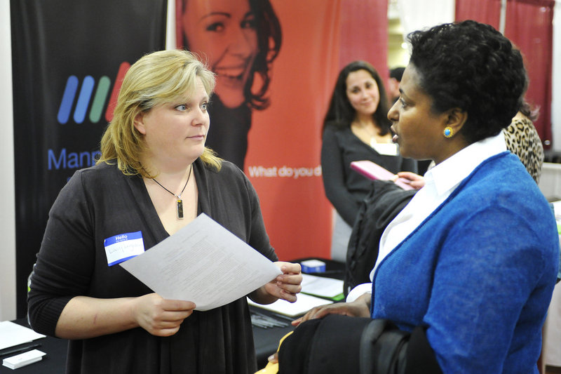 Manpower representative Mary Leighton, left, accepts a resume from Tegest Herrmann during the Maine Sunday Telegram/Monster Career Fair held Tuesday at the Italian Heritage Center in Portland. Forty-five companies participated in the fair.