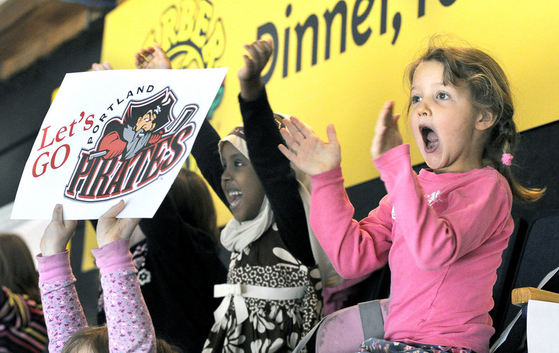 Reiche Community School kindergartners Nasteeho Mohamud, 5, left, and Greta Holmes, 6, are among more than 3,600 students from more than 20 schools taking time out from classes Tuesday to watch the Portland Pirates play the Worcester Sharks at the Cumberland County Civic Center in Portland.
