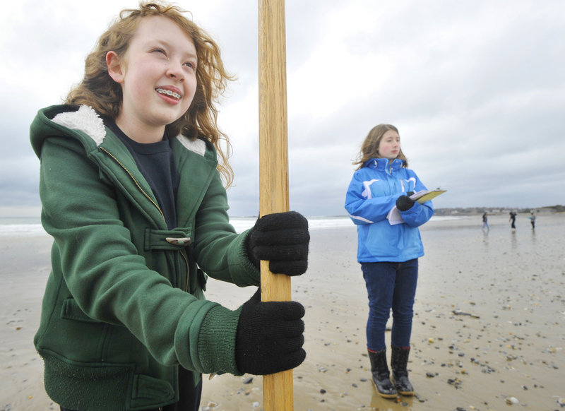 Genny Guibord, left, and Scarborough Middle School classmate Sarah Griffin record the slope of the beach as part of the Southern Maine Beach Profile Monitoring Project.