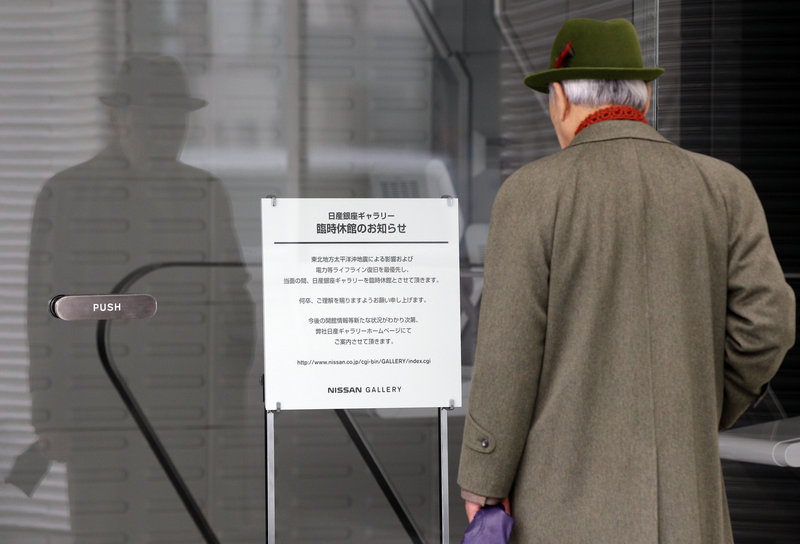 A man reads a notice announcing that a Nissan showroom in Tokyo is closed temporarily because of the March 11 earthquake and tsunami. Nissan is studying whether to have its Dechard, Tenn., plant supply six-cylinder engines to Japan.