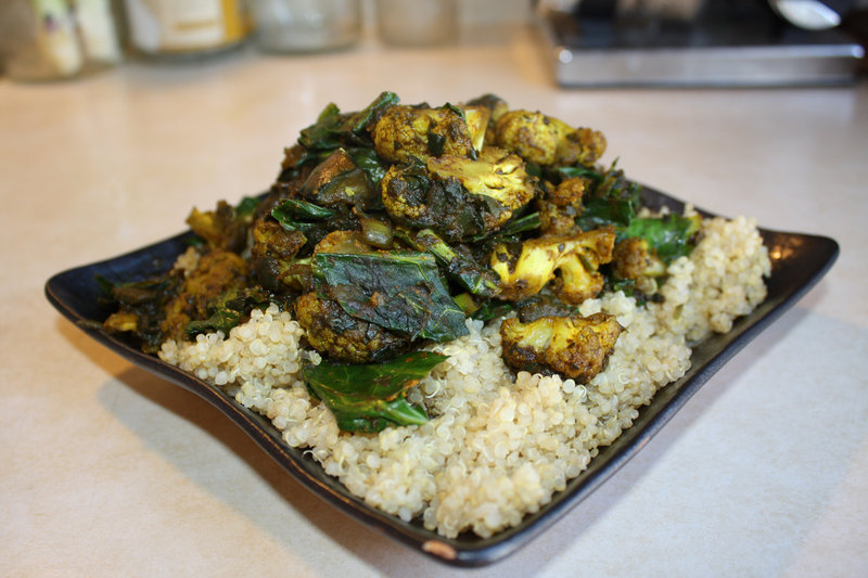 A curry with onions, eggplant, cauliflower, spinach and collard greens, which is served on a bed of quinoa. Find recipes for similar curries on Norster's blog.