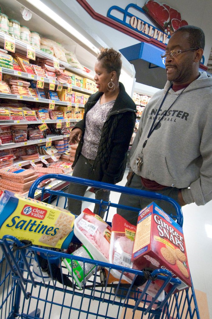 Andrea Long and Darryl Witherspoon select some Clear Value products at a Bi-Lo supermarket in Charlotte, N.C. Since the recession’s onset, store brands’ sales have grown.