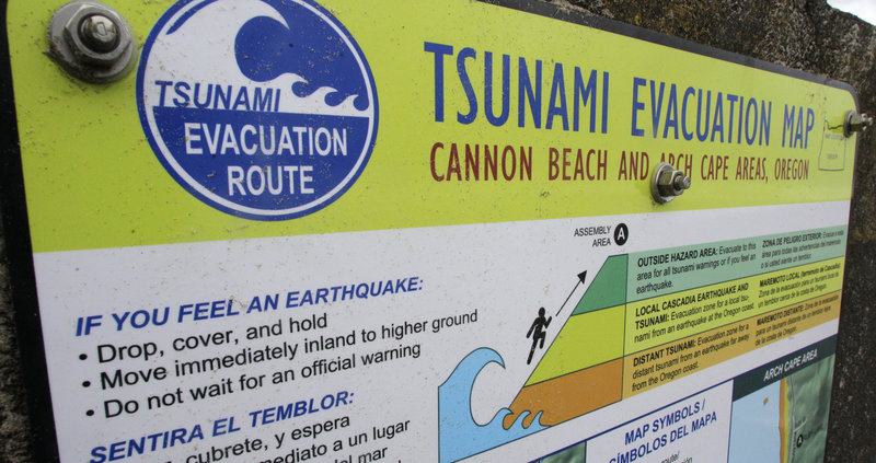 This tsunami evacuation sign in Cannon Beach, Ore., tells people what action to take.