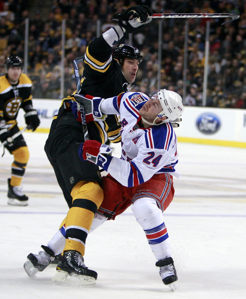 Zdeno Chara, left, works to get around New York’s Ryan Callahan during the Rangers’ 1-0 win Saturday. Callahan and the Rangers helped goalie Henrik Lundqvist earn his 11th shutout.