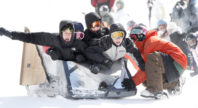 Cardboard box racers, from left, Jack Elder, Julia Primeau, Chapin Dorsett and Rhys Eddy, all 14-year-olds from Yarmouth, get a push as they take off in their Millenium Falcon at Saddleback Mountain in Rangeley on Saturday.