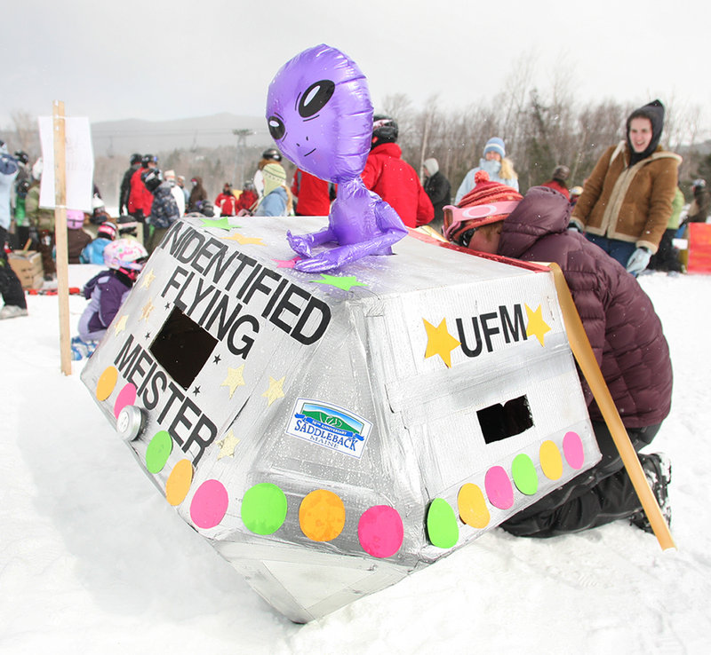 A cardboard craft gets finishing touches before the race. Competitors were judged for the creativity of their sleds, and for whether they made it to the bottom
