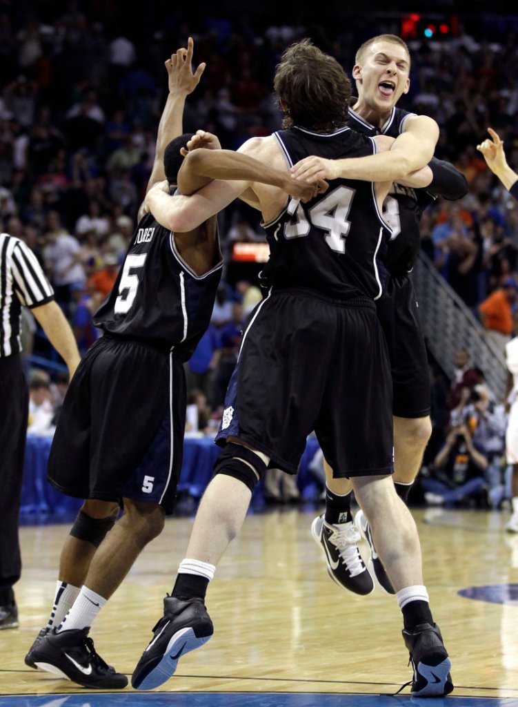 Zach Hahn celebrates Saturday with Matt Howard, 54, and Ronald Nored, left, after Butler earned a second consecutive appearance in the Final Four with a 74-71 overtime victory against Florida.