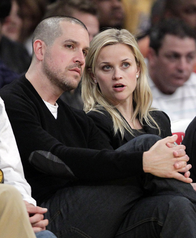 Actress Reese Witherspoon and her fiance, Jim Toth, watch an NBA basketball game between the Los Angeles Lakers and the Detroit Pistons in Los Angeles in January.
