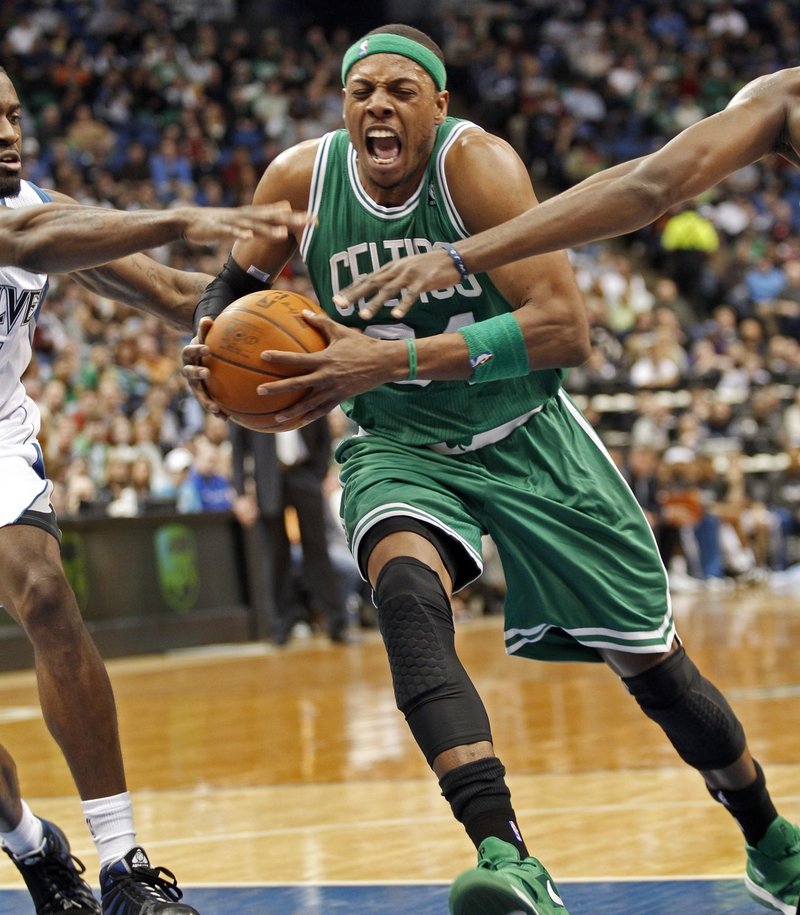 Paul Pierce drives the lane against a pair of Minnesota defenders during Boston’s 85-82 win Sunday night. Pierce scored a pair of late baskets to help the Celtics.