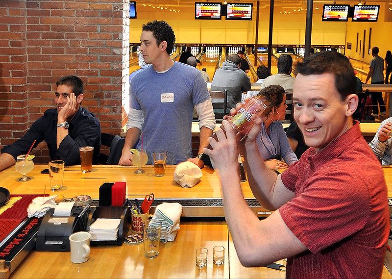 Owner and bartender Charlie Mitchell shakes up a margarita at Bayside Bowl.