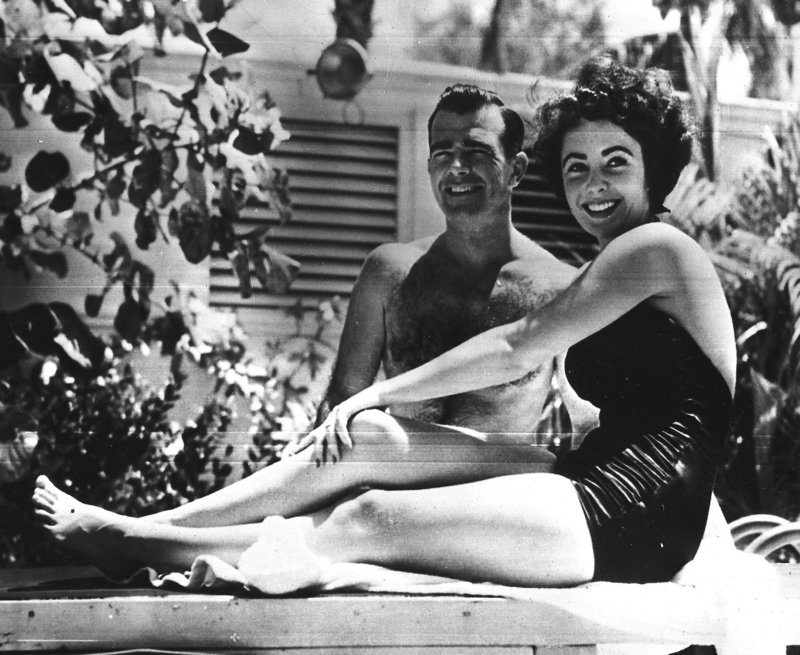 A 17-year-old Elizabeth Taylor poses in June 1949 with fiance William D. Pawley Jr. at his father’s home in Miami Beach, Fla. More than 60 love letters written by the actress, who died last week at age 79, will be put up for auction by RR Auction in Amherst, N.H.