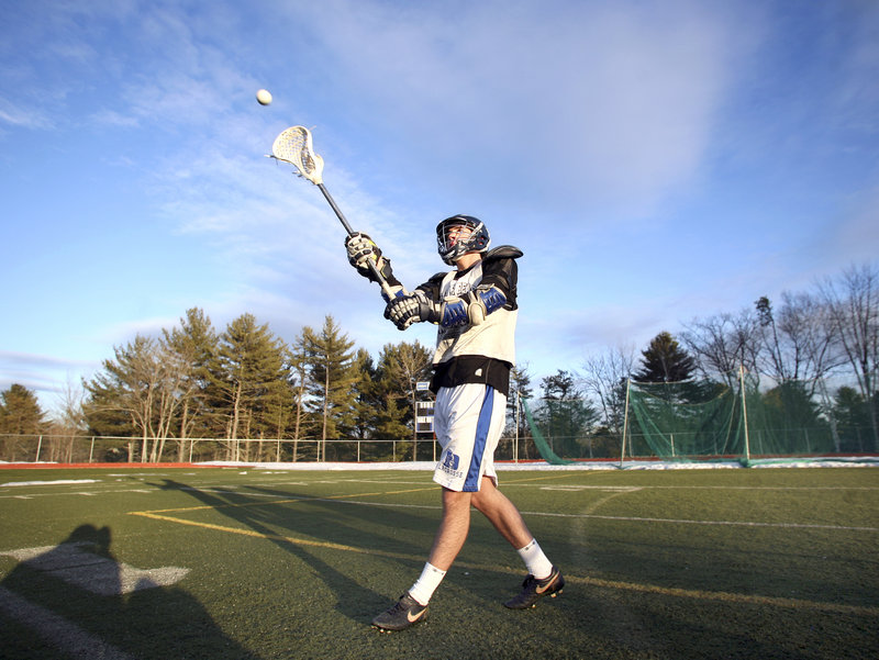 Senior Kyle Groves plays catch during boys lacrosse practice at Yarmouth High on Monday afternoon. Some teams took to their turf fields, while others convened in school gyms until as late as 10 p.m. Monday.