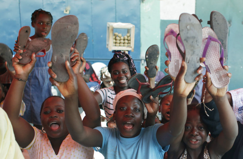 Supporters of Alassane Ouattara raise their shoes, symbolizing the placing of a curse on incumbent leader Laurent Gbagbo, after participating in a special Muslim prayer in honor of the civilians killed in three months of post-election violence, at a mosque in Abidjan, Ivory Coast, on Friday.