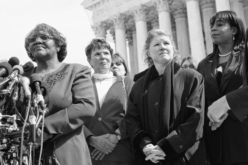 Plaintiffs in a case of women employees against Walmart, from left, Betty Dukes, of Pittsburg, Calif., Deborah Gunter, of Palm Springs, Calif., Christine Kwapnoski, of Bay Point, Calif., and Edith Arena, of Duarte, Calif., take part in a news conference Tuesday outside the Supreme Court in Washington.
