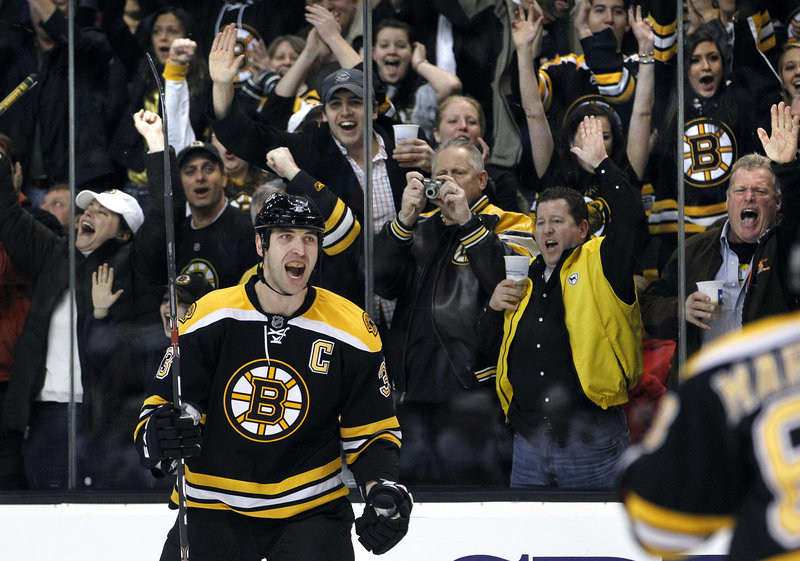 As the Bruins’ fans cheer Tuesday night, defenseman Zdeno Chara turns to his teammates after scoring against the Chicago Blackhawks in the second period of a 3-0 victory.
