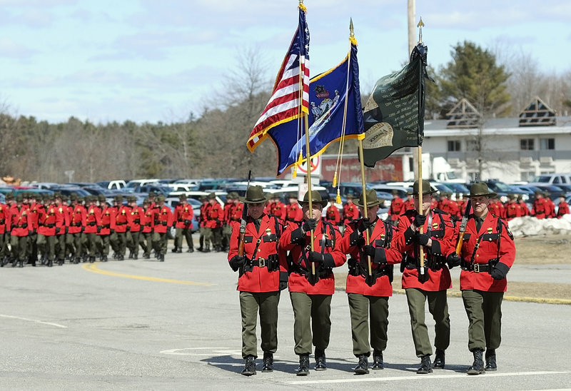 The Maine Warden Service color guard leads a procession of law enforcement officers at Wednesday’s memorial service for warden service pilot Daryl Gordon at the Augusta Civic Center. He was the first game warden to die in the line of duty since 1992.