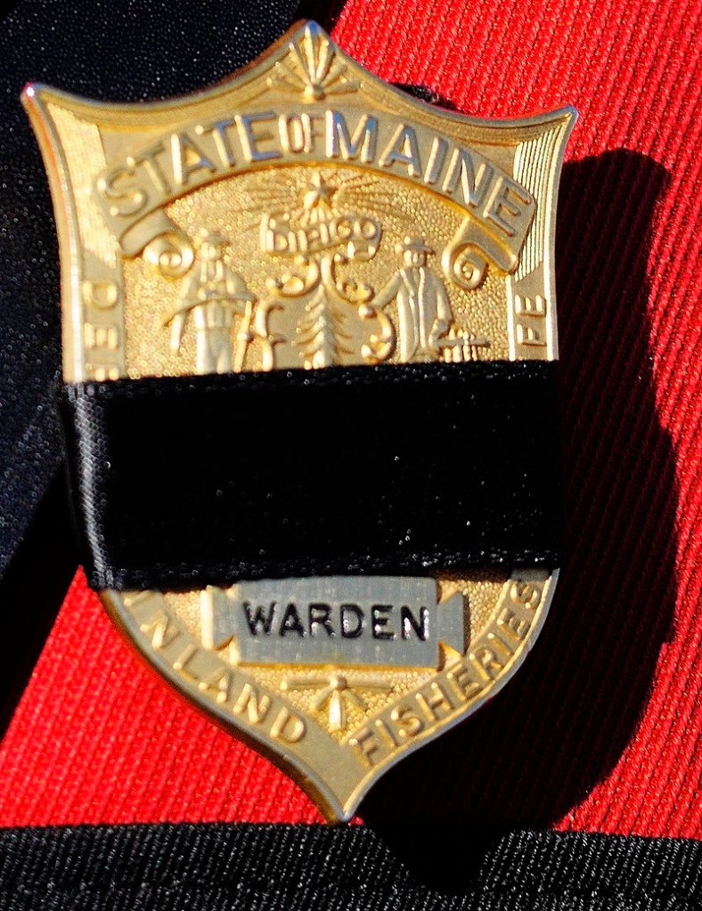Warden service officers wore black bands on their badges to mark the loss of a member of their “brotherhood.”