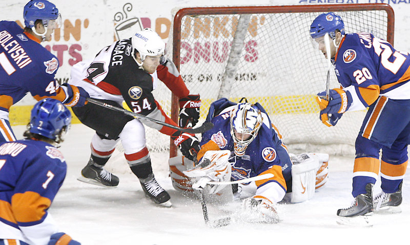 Jacob Lagace of the Pirates gets inside the Bridgeport defense and tries to stuff the puck past goalie Mikko Koskinen in the Sound Tigers' 2-1 win Wednesday night.