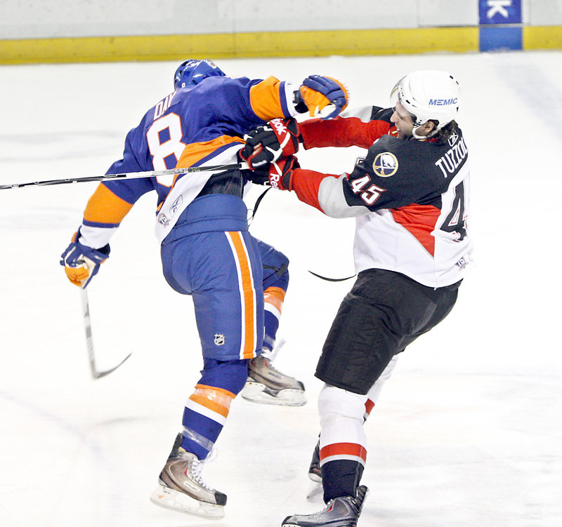 Nick Tuzzolino, right, of the Pirates knocks down Brian Day of the Sound Tigers during Wednesday night's game. Bridgeport beat Portland for the second time in six nights.