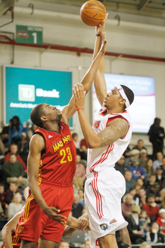 Magnum Rolle, who scored 23 points for the Red Claws, lofts a shot over Anthony Kent of Fort Wayne at the Portland Expo.