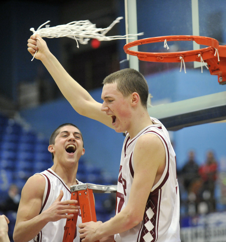 Patrick Steward makes the final cut and twirls the net as Nick Sherwood joins him on the ladder to celebrate Bangor’s state championship victory.