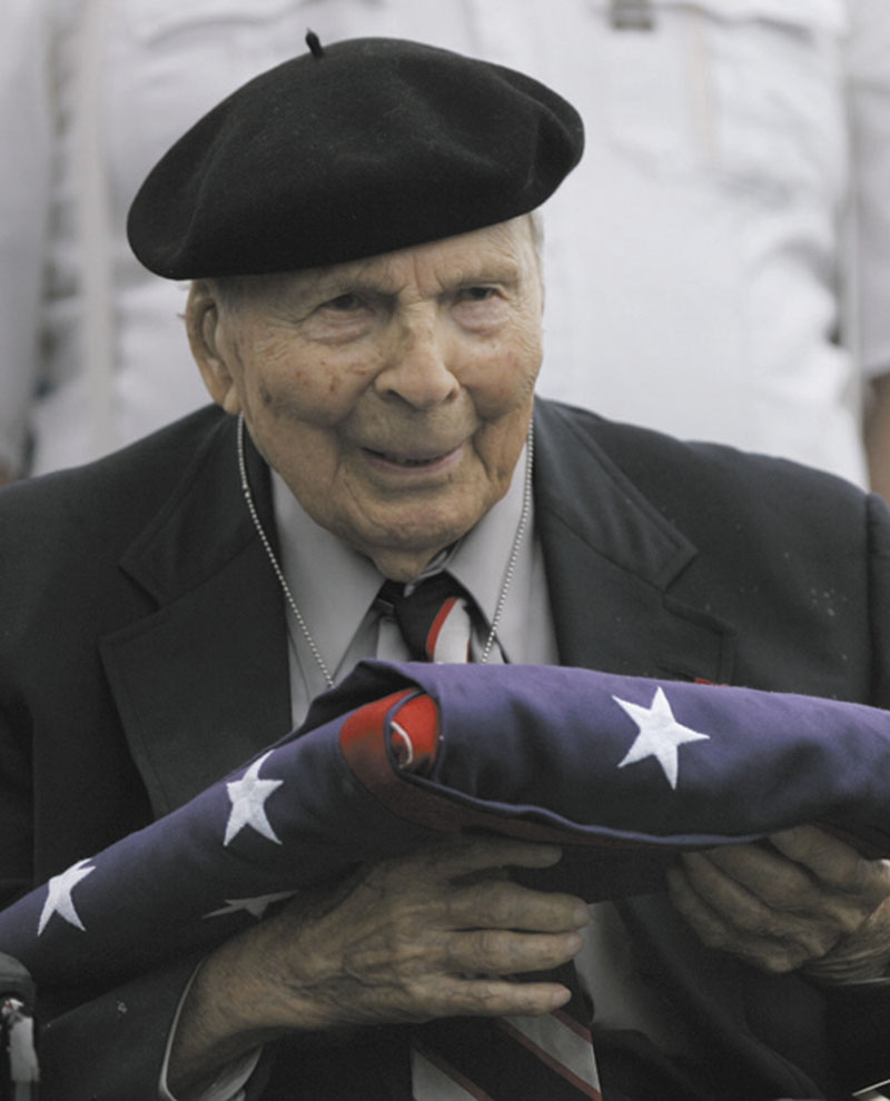 In a May 26, 2008, file photo Frank Buckles receives an American flag during Memorial Day activities at the National World War I Museum in Kansas City, Mo.