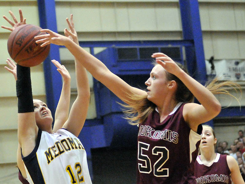 STRONG INSIDE: Nokomis’ Danielle Watson, right, blocks a shot from Medomak Valley’s Lindsay Ranquist in the Eastern Maine Class B championship game Saturday at the Bangor Auditorium. Watson is a big reason the Warriors will play Leavitt for the Class B state championship at 7 p.m. Friday in Portland.