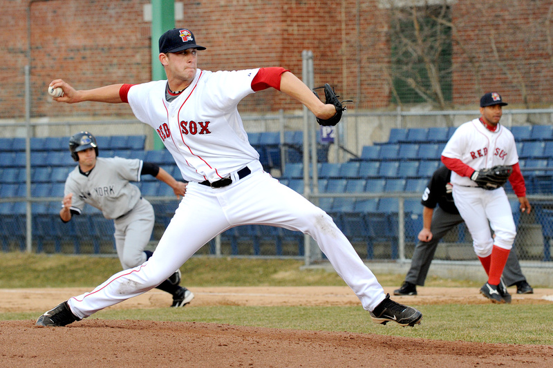 Sea Dog Michael Lee pitches to the Trenton Thunder Monday during “Turn the Clock Ahead” night at Hadlock Field. The Sea Dogs wore Red Sox uniforms; the Trenton Thunder wore Yankee uniforms.