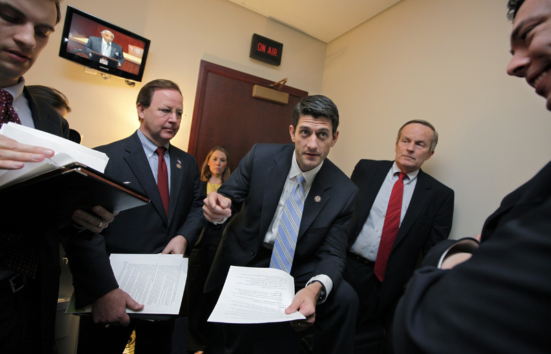 House Budget Committee Chairman Paul Ryan, R-Wis., works with fellow Republican members of the panel on Capitol Hill last week. He is flanked by Rep. Todd Akin, R-Mo., right, and Rep. Bill Flores, R-Texas, left.