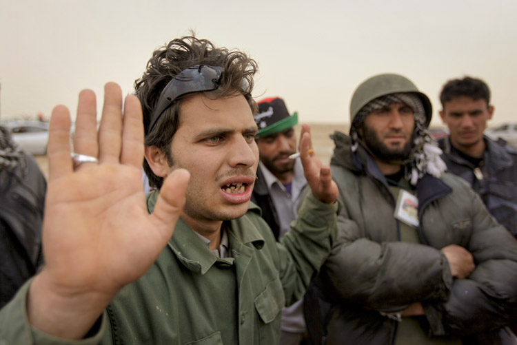 A Libyan rebel fighter expresses anger today on hearing from other rebels that a NATO airstrike farther up the road toward Brega had hit rebel forces, killing at least two and injuring more than a dozen.