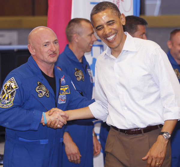 President Barack Obama meets with Space Shuttle Endeavor commander Mark Kelly, husband of wounded Rep. Gabrielle Giffords, D-Ariz., and shuttle astronauts, after their launch was scrubbed today at Kennedy Space Center in Cape Canaveral, Fla.