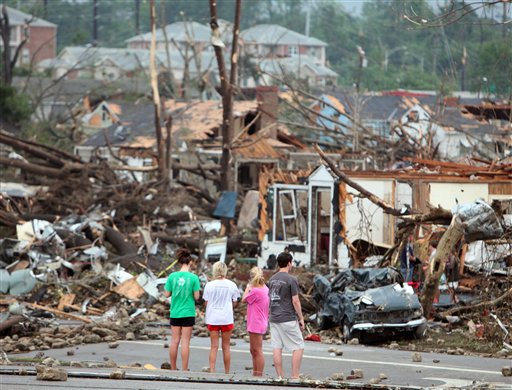 Bystanders look on at storm damage along 15th Street in Tuscaloosa, Ala., Wednesday, April 27, 2011. A strong tornado moved through the city Wednesday afternoon. (AP Photo/The Tuscaloosa News, Dusty Compton) storm