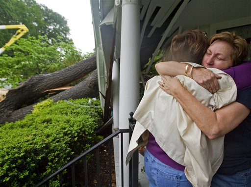 Mae Woody Christopher is comforted by a friend after a large oak tree split and crashed into her 7th Street home, Wednesday, April 27, 2011 in Tuscumbia, Ala. (AP Photo/TimesDaily,Daniel Giles)