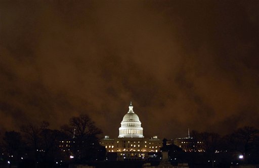 Lights burned in the U.S. Capitol under storm clouds illuminated by the city lights late Friday as Congress struggled to reach a budget compromise to keep the government funded.