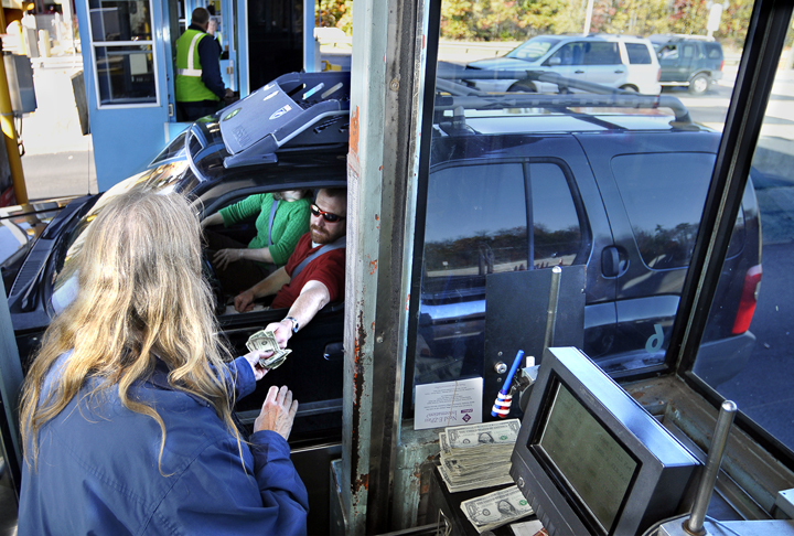 A driver receives his change from a toll collector at the York Toll plaza. The turnpike authority employs 250 full-time and part-time toll collectors.
