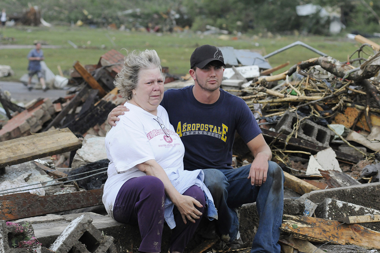 Judy Cook, who lost her home, is comforted by Chase Spradlin in Concord, Ala., Wednesday.