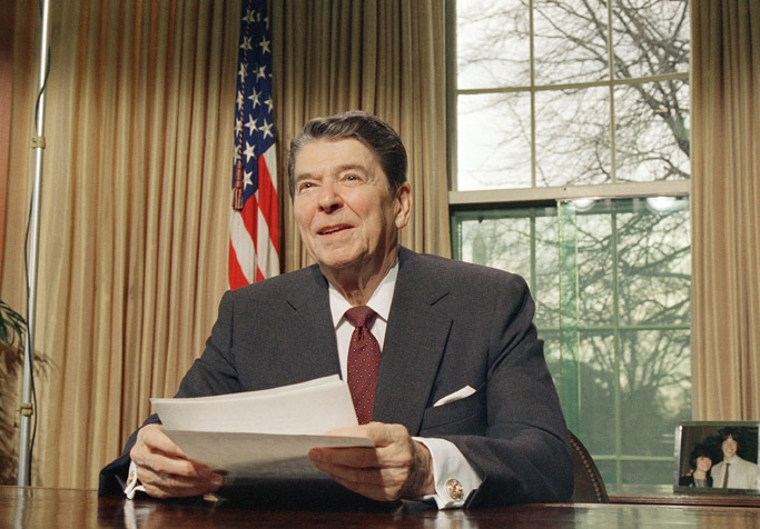 In a 1987 file photo, President Ronald Reagan makes a televised speech at the White House. His bio says the nation enjoyed "its longest recorded period of peacetime prosperity without recession or depression" at the end of his second term, in 1989.