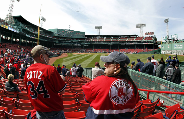 Fans Sean Kuusisaari, left, of Dartmouth, Mass., and Meghann Mullaly of Swansea, Mass., take in the sights at their seats in right field today at Fenway Park prior to the Red Sox home opener against the New York Yankees.
