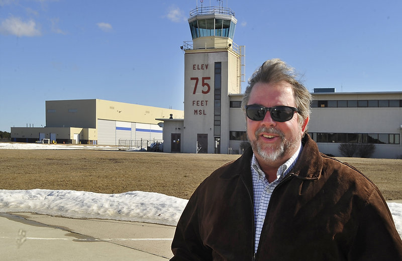 Steve Levesque, executive director of the Midcoast Regional Redevelopment Authority. stands last week at the Brunswick Executive Airport, a civilian enterprise that has been launched on the site of the former Brunswick Naval Air Station.