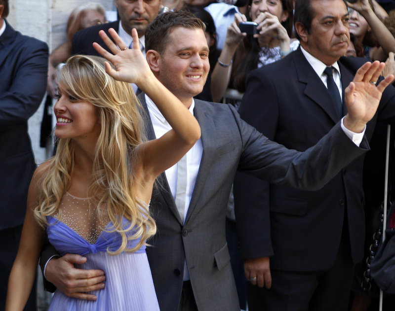 Pop star Michael Buble and his new wife, Luisana Lopilato, wave to fans after their civil wedding ceremony in Buenos Aires on Thursday.