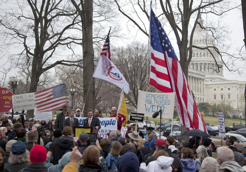 In a steady drizzle, about 500 people staged a tea party “Continuing Revolution Rally” Thursday on Capitol Hill in Washington, chanting, “We want less.” But no major Republican congressional leaders showed up.