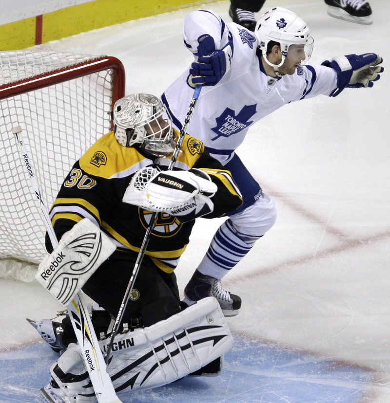 Bruins goalie Tim Thomas grabs the stick of Toronto left wing Darryl Boyce during the Maple Leafs’ shootout win.