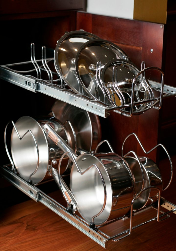 A pull-out pot rack installed in a kitchen cabinet can save precious space.