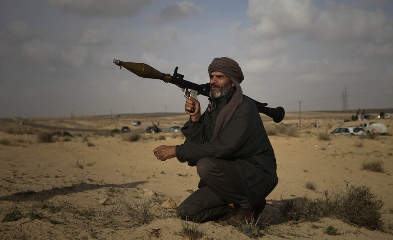 A Libyan rebel holds a rocket launcher Friday near the oil port of Brega. The rebels have been in retreat for three days as Col. Moammar Gadhafi’s troops regain the initiative.