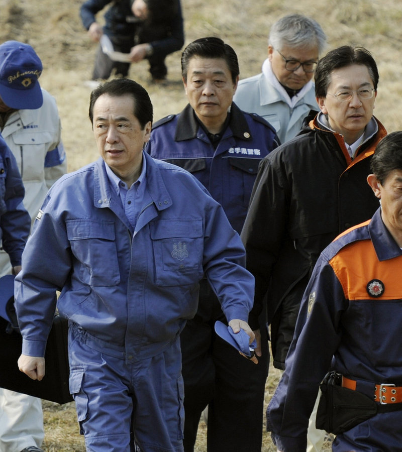 Japanese Prime Minister Naoto Kan, left, arrives in Rikuzentakata, Japan, today to survey the devastation from the March 11 earthquake and tsunami.