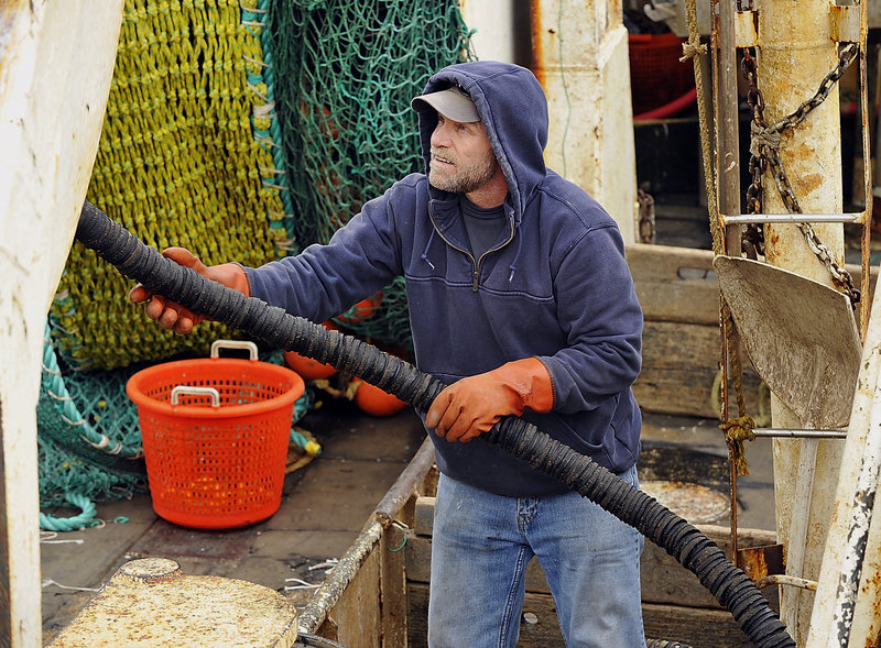 Alden Leeman of Harpswell, captain of the Jennifer and Emily, a groundfishing dragger, works on his net gear while docked at the Portland Fish Exchange pier. “We are fishing a lot harder,” he said.